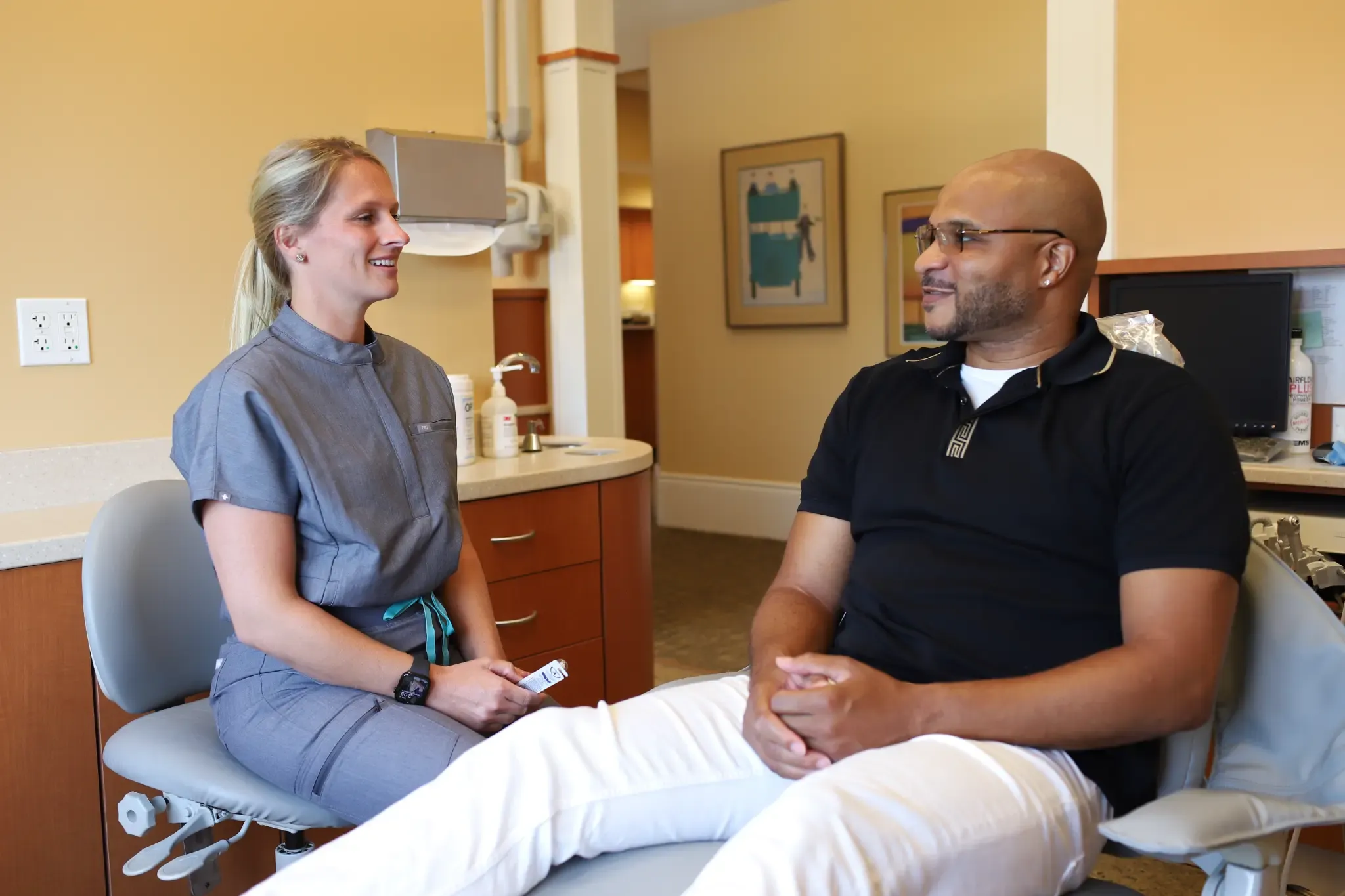 A Grandville Dental hygienist speaking with a patient in a treatment room