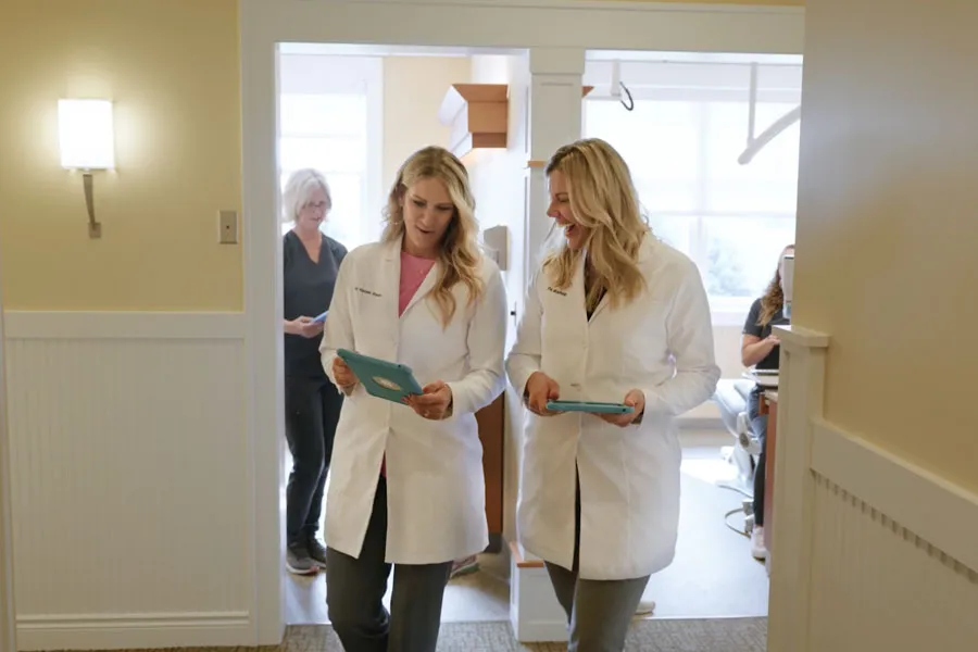 Two Grandville Dental clinicians discussing patient care in the practice